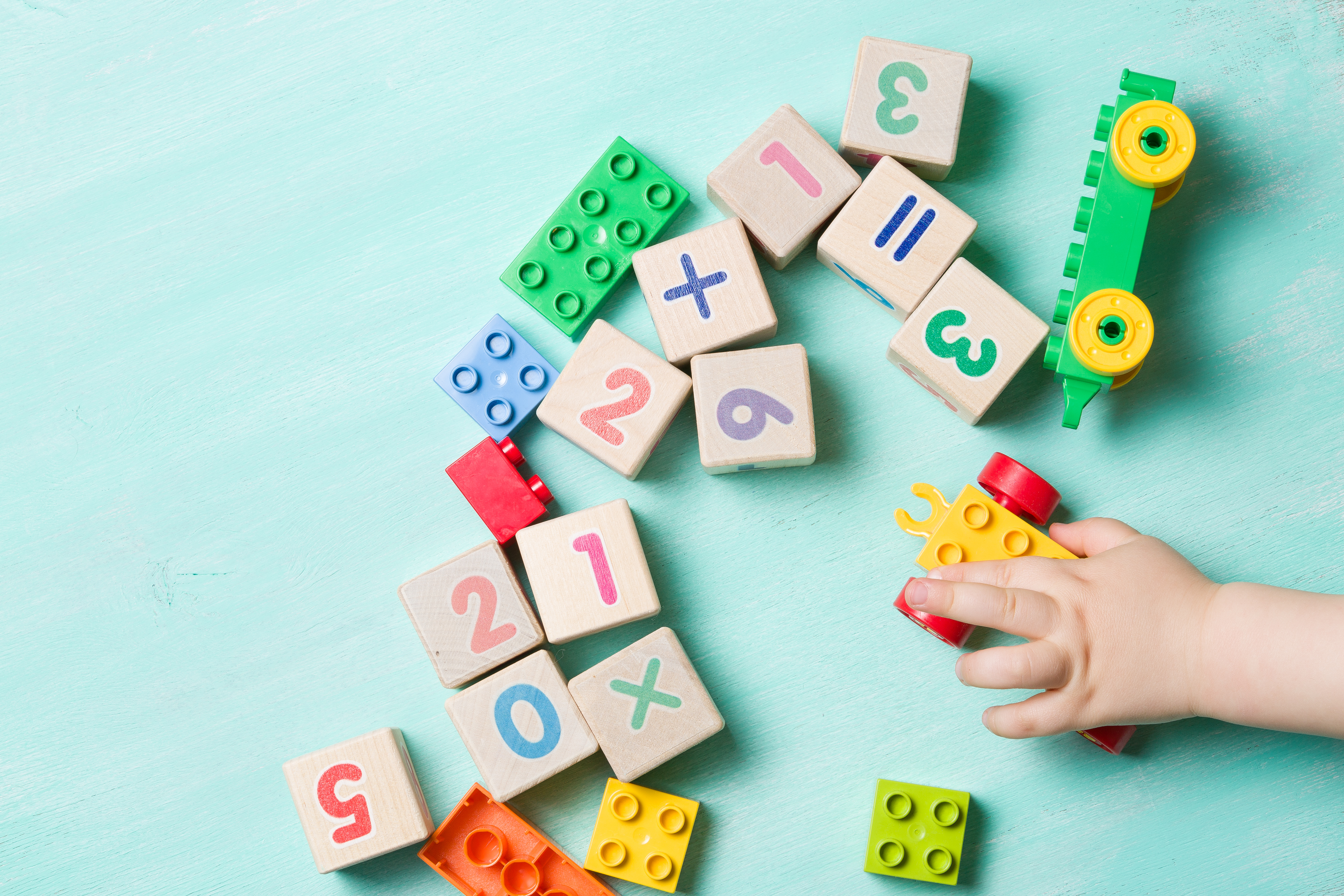 Child,Playing,With,Wooden,Cubes,With,Numbers,And,Colorful,Toy