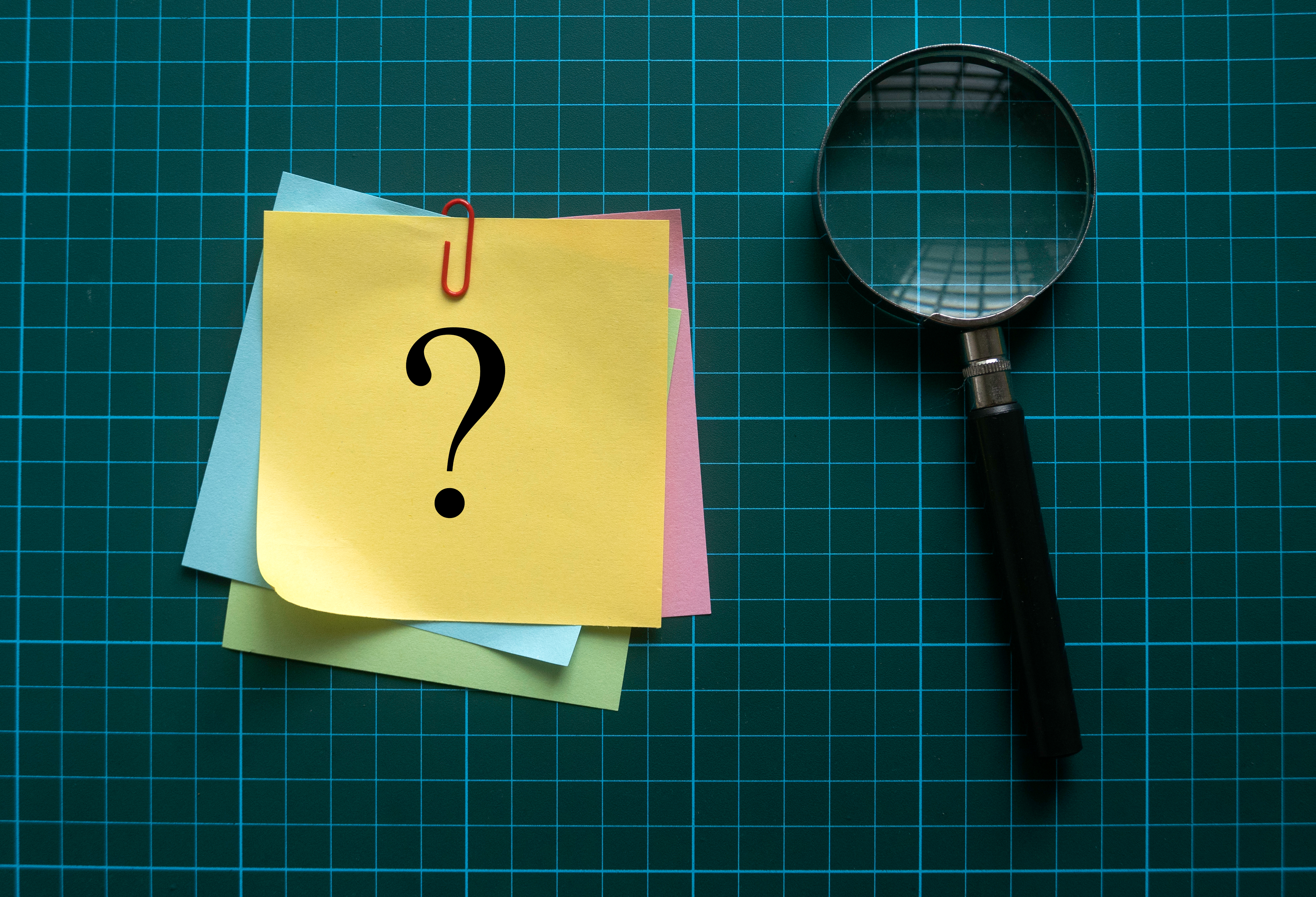 Top,View,Of,Magnifying,Glass,And,A,Stack,Of,Memo