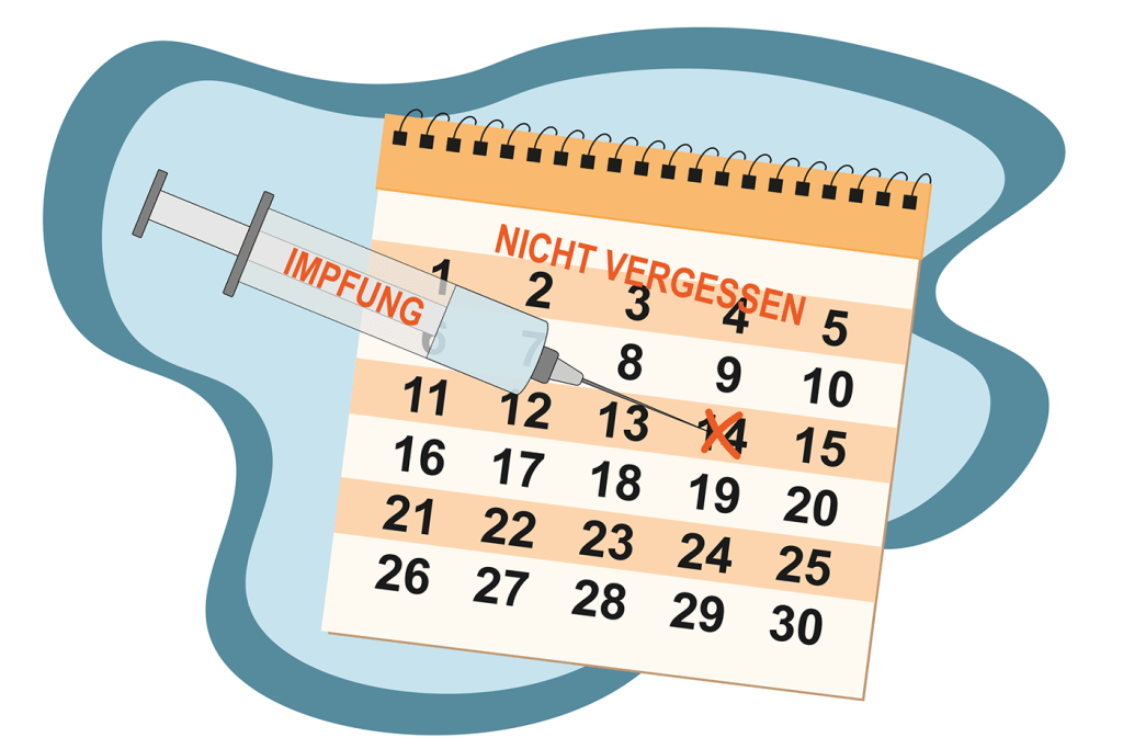 Kalender mit Marker und Spritze als Erinnerung an den Impftermin